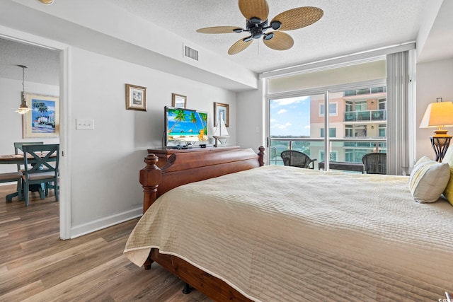 2001 S Ocean Blvd Unit 901, North Myrtle Beach, SC 29582 - bedroom featuring wood finished floors, a textured ceiling, expansive windows, and ceiling fan
