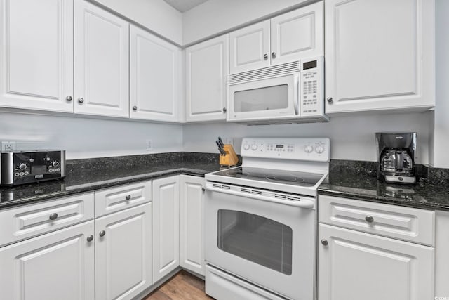 2001 S Ocean Blvd Unit 901, North Myrtle Beach, SC 29582 - kitchen featuring white appliances, white cabinetry, dark stone counters, and light wood-style flooring