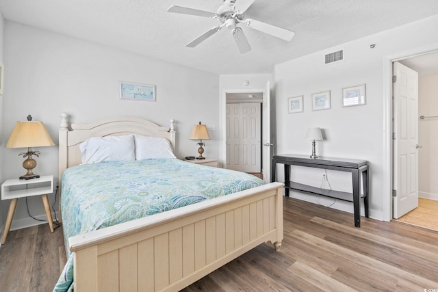 2001 S Ocean Blvd Unit 901, North Myrtle Beach, SC 29582 - bedroom featuring wood finished floors, a textured ceiling, a closet, and ceiling fan