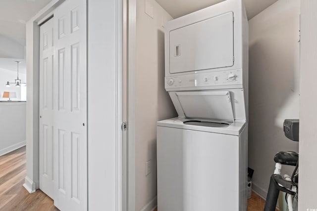 2001 S Ocean Blvd Unit 901, North Myrtle Beach, SC 29582 - washroom featuring stacked washer / drying machine and light wood-style flooring
