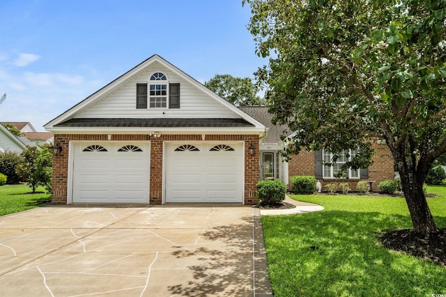 3845 Camden Dr, Myrtle Beach, SC 29588 - view of front facade featuring brick siding, a garage, a front yard, and driveway