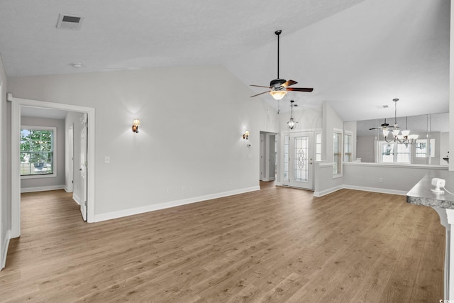 3845 Camden Dr, Myrtle Beach, SC 29588 - unfurnished living room with light wood-style flooring, a ceiling fan, a chandelier, and high vaulted ceiling
