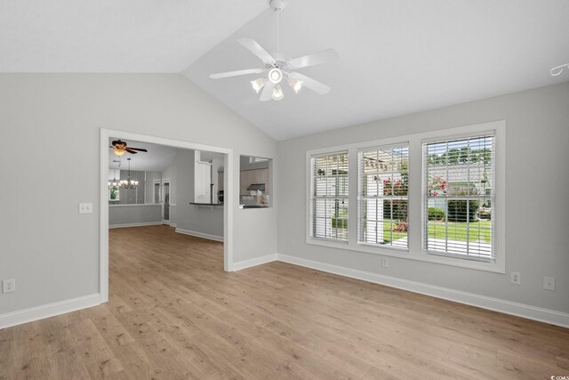 3845 Camden Dr, Myrtle Beach, SC 29588 - empty room with light wood-type flooring, a ceiling fan, vaulted ceiling, and a chandelier