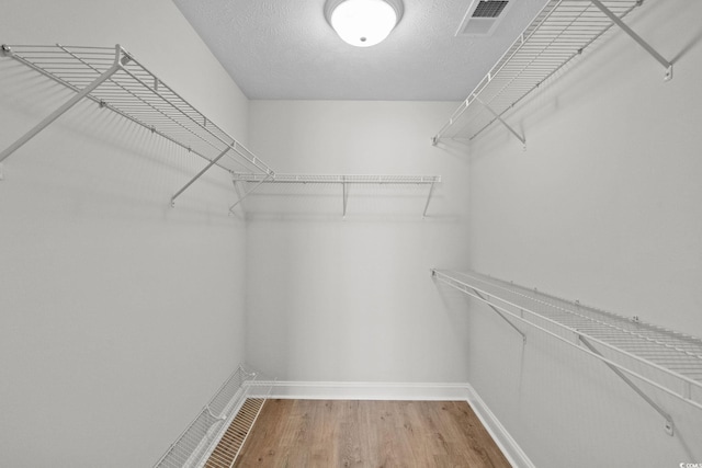 3845 Camden Dr, Myrtle Beach, SC 29588 - walk in closet featuring wood finished floors
