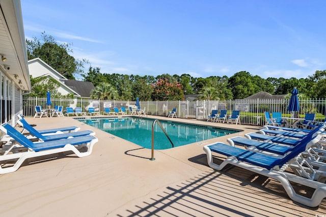 3845 Camden Dr, Myrtle Beach, SC 29588 - community pool with a patio and view of scattered trees