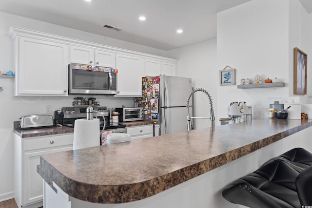 805 Spyderco Rd, Conway, SC 29527 - kitchen with appliances with stainless steel finishes, dark countertops, white cabinetry, and recessed lighting