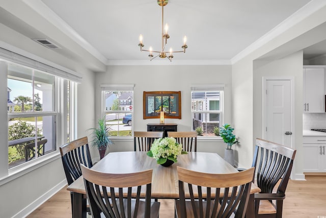 8906 Freya Way Unit 24A, Longs, SC 29568 - dining area featuring plenty of natural light, a chandelier, light wood-style flooring, and ornamental molding