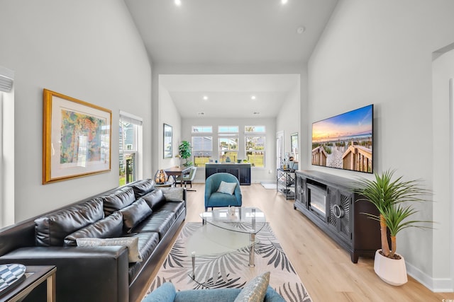 8906 Freya Way Unit 24A, Longs, SC 29568 - living area featuring light wood-type flooring, recessed lighting, a glass covered fireplace, and lofted ceiling