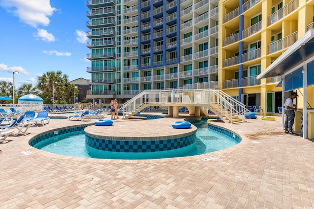 304 N Ocean Blvd Unit 1402, North Myrtle Beach, SC 29582 - community pool featuring stairway and a patio area