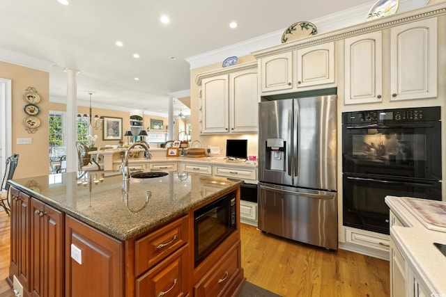 3085 Luvan Blvd, Georgetown, SC 29440 - kitchen with black appliances, cream cabinets, ornamental molding, light wood-type flooring, and recessed lighting