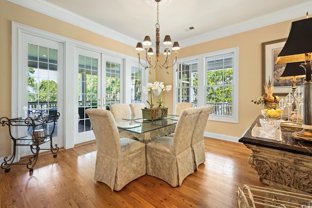 3085 Luvan Blvd, Georgetown, SC 29440 - dining area with french doors, a chandelier, wood finished floors, and ornamental molding