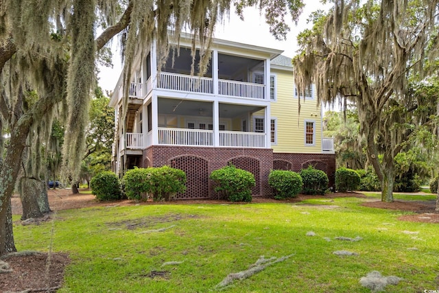 3085 Luvan Blvd, Georgetown, SC 29440 - rear view of property featuring a sunroom and a lawn