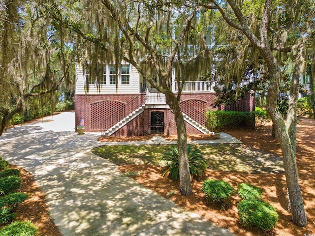 3085 Luvan Blvd, Georgetown, SC 29440 - view of front of house featuring brick siding, stairway, and driveway