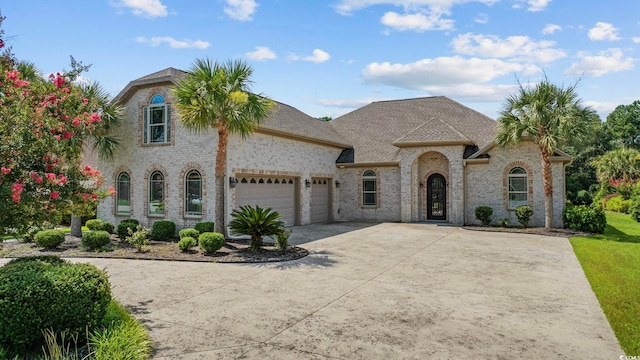 8444 Juxa Dr, Myrtle Beach, SC 29579 - view of front of property featuring an attached garage, brick siding, and driveway