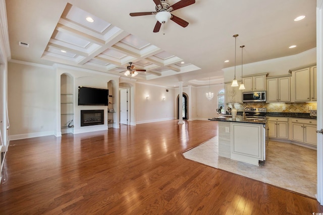 8444 Juxa Dr, Myrtle Beach, SC 29579 - kitchen featuring cream cabinetry, a ceiling fan, arched walkways, appliances with stainless steel finishes, and open floor plan