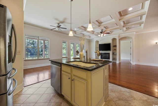 8444 Juxa Dr, Myrtle Beach, SC 29579 - kitchen with stainless steel appliances, a ceiling fan, cream cabinetry, open floor plan, and arched walkways