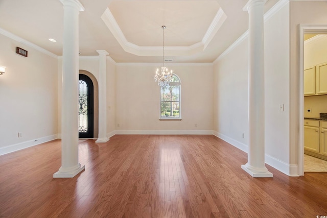 8444 Juxa Dr, Myrtle Beach, SC 29579 - foyer featuring a tray ceiling, light wood finished floors, arched walkways, and crown molding