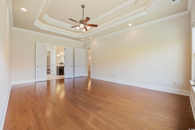 8444 Juxa Dr, Myrtle Beach, SC 29579 - unfurnished bedroom featuring a raised ceiling, light wood-style floors, and ornamental molding