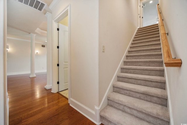 8444 Juxa Dr, Myrtle Beach, SC 29579 - stairs featuring decorative columns, wood finished floors, and ornamental molding