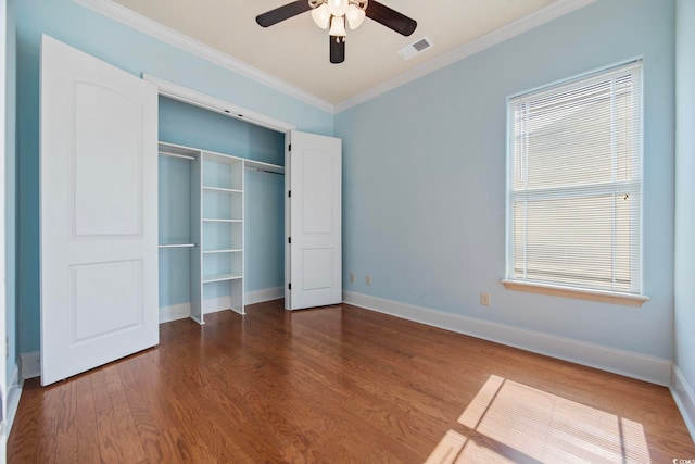 8444 Juxa Dr, Myrtle Beach, SC 29579 - unfurnished bedroom with crown molding, wood finished floors, a closet, and ceiling fan