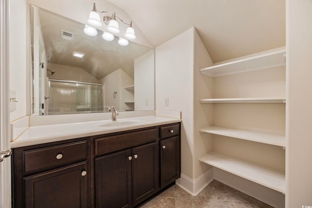 8444 Juxa Dr, Myrtle Beach, SC 29579 - bathroom featuring lofted ceiling, vanity, a shower stall, and tile patterned floors