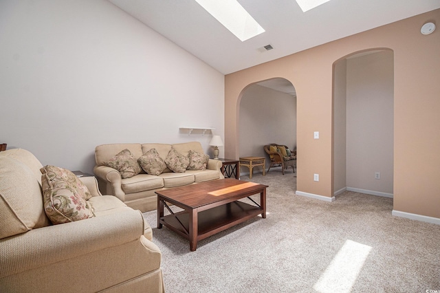4530 Lighthouse Dr Unit 31-C, Little River, SC 29566 - living room featuring arched walkways, a skylight, light colored carpet, and lofted ceiling