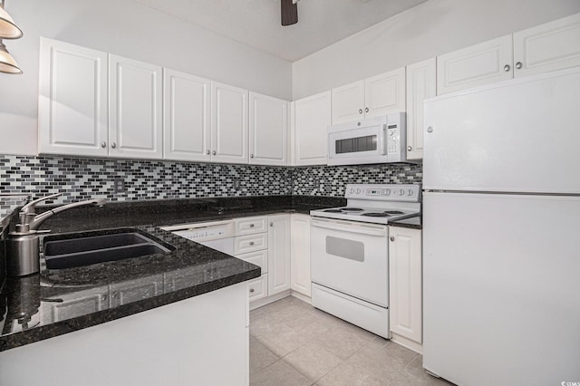 4530 Lighthouse Dr Unit 31-C, Little River, SC 29566 - kitchen with white appliances, white cabinetry, backsplash, light tile patterned flooring, and dark stone counters