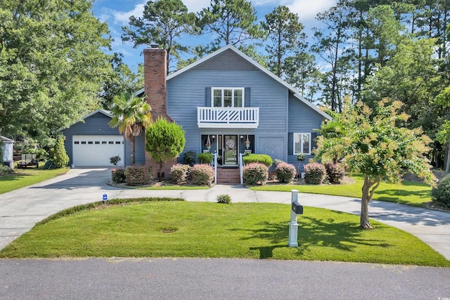 106 Furman Cir, Conway, SC 29526 - view of front facade featuring a balcony, concrete driveway, a garage, a front yard, and a chimney