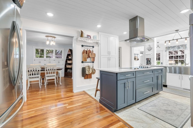 106 Furman Cir, Conway, SC 29526 - kitchen with freestanding refrigerator, island range hood, white cabinetry, light countertops, and light wood-style floors