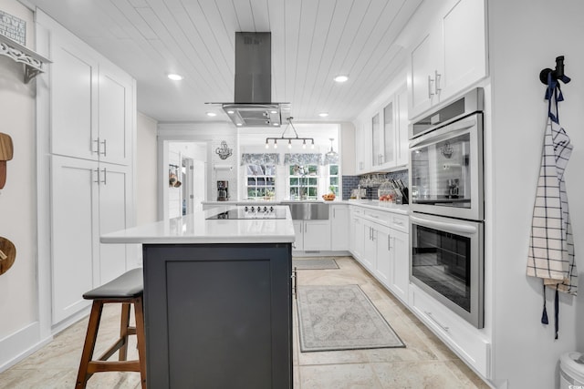 106 Furman Cir, Conway, SC 29526 - kitchen featuring double oven, island exhaust hood, white cabinets, a kitchen breakfast bar, and light countertops