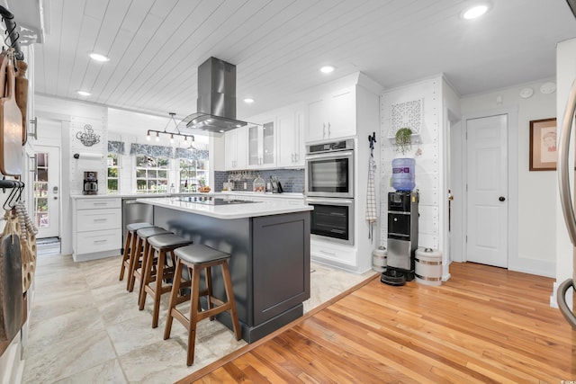 106 Furman Cir, Conway, SC 29526 - kitchen featuring island range hood, double oven, white cabinets, recessed lighting, and a kitchen breakfast bar