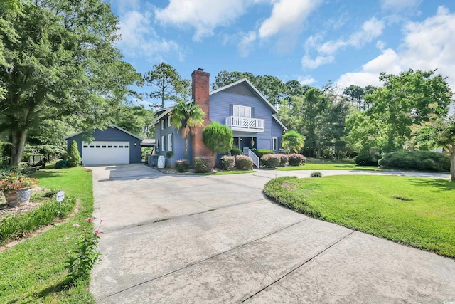 106 Furman Cir, Conway, SC 29526 - view of front of home with a balcony, a front lawn, an outdoor structure, a chimney, and a detached garage