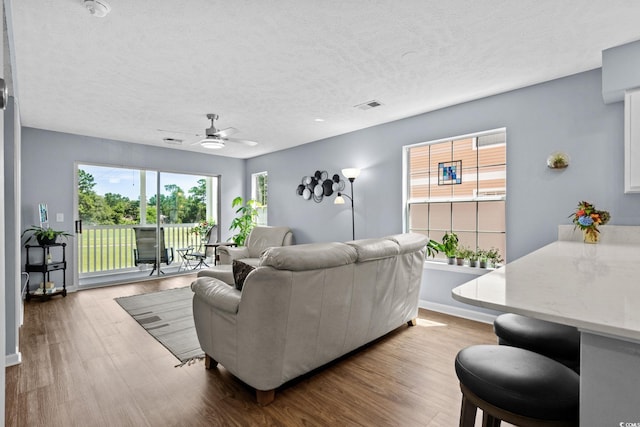 613 Waterway Village Blvd Unit 4-F, Myrtle Beach, SC 29579 - living room featuring a ceiling fan, wood finished floors, and a textured ceiling