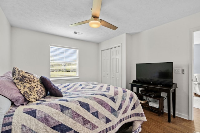 613 Waterway Village Blvd Unit 4-F, Myrtle Beach, SC 29579 - bedroom featuring wood finished floors, a closet, a textured ceiling, and ceiling fan