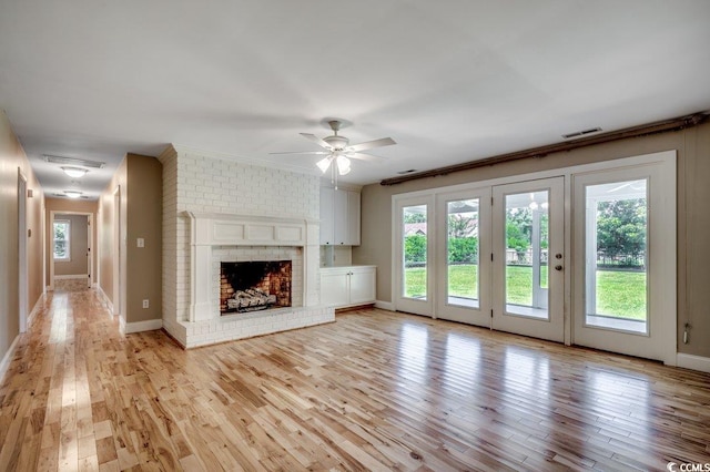 414 Dunes Dr, Myrtle Beach, SC 29572 - unfurnished living room with healthy amount of natural light, light wood finished floors, ceiling fan, and a fireplace