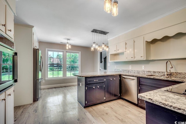 414 Dunes Dr, Myrtle Beach, SC 29572 - kitchen with appliances with stainless steel finishes, white cabinetry, a peninsula, light wood-type flooring, and crown molding