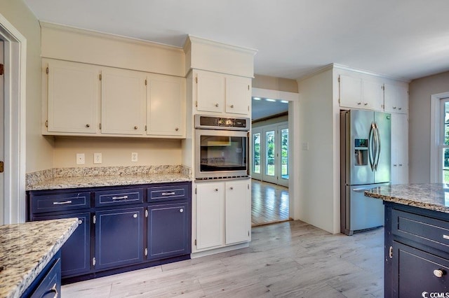 414 Dunes Dr, Myrtle Beach, SC 29572 - kitchen with stainless steel appliances, blue cabinets, white cabinetry, light wood-type flooring, and crown molding