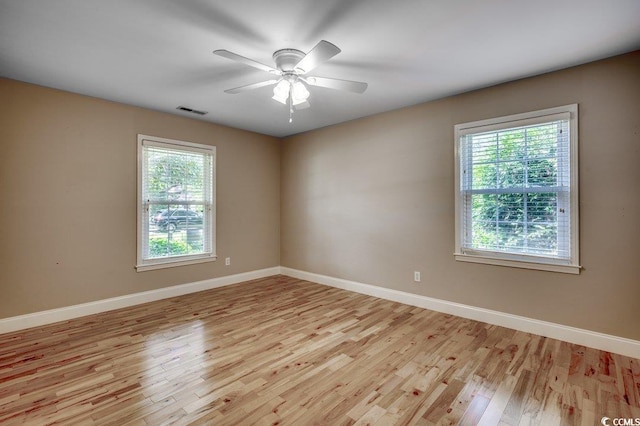 414 Dunes Dr, Myrtle Beach, SC 29572 - empty room with light wood-style floors, plenty of natural light, and ceiling fan