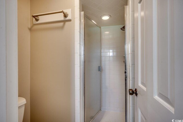 414 Dunes Dr, Myrtle Beach, SC 29572 - bathroom featuring a stall shower and toilet