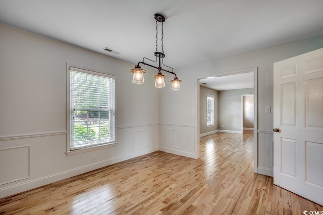 414 Dunes Dr, Myrtle Beach, SC 29572 - unfurnished room with light wood-style floors, plenty of natural light, and wainscoting
