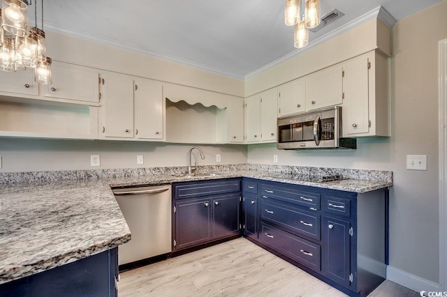414 Dunes Dr, Myrtle Beach, SC 29572 - kitchen with appliances with stainless steel finishes, blue cabinetry, light wood finished floors, white cabinetry, and ornamental molding