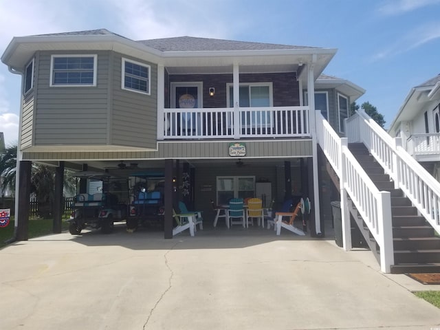 919 Dock Pl, Murrells Inlet, SC 29576 - view of front of house with driveway, stairs, a shingled roof, and a carport