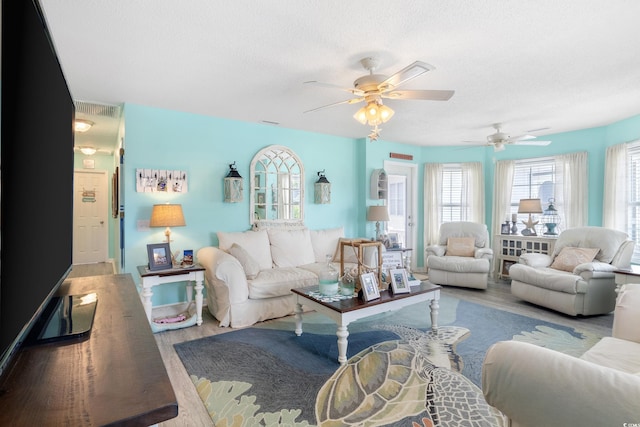 919 Dock Pl, Murrells Inlet, SC 29576 - living area featuring ceiling fan, wood finished floors, plenty of natural light, and a textured ceiling