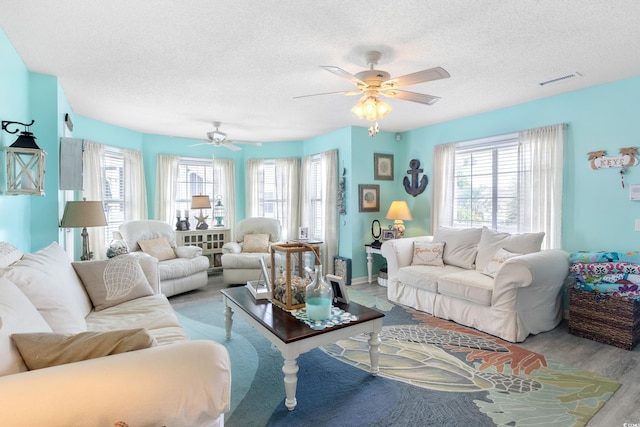 919 Dock Pl, Murrells Inlet, SC 29576 - living area with a textured ceiling, healthy amount of natural light, wood finished floors, and ceiling fan