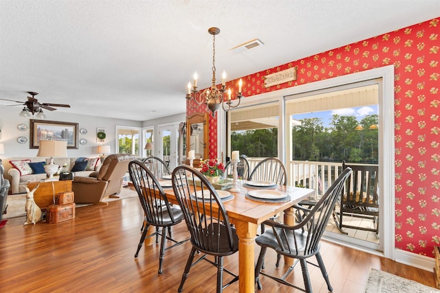 460 River Front St S, Conway, SC 29527 - dining space with wood finished floors, wallpapered walls, a chandelier, ceiling fan, and a textured ceiling