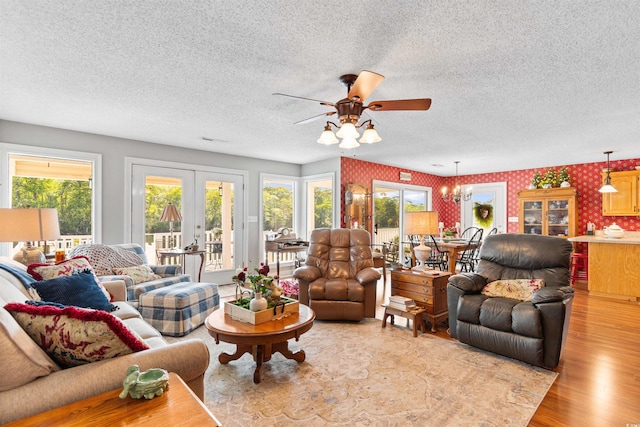 460 River Front St S, Conway, SC 29527 - living area featuring ceiling fan, light wood finished floors, wallpapered walls, a textured ceiling, and a chandelier