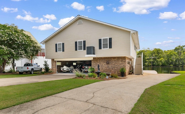 460 River Front St S, Conway, SC 29527 - view of side of home with brick siding, driveway, stairway, a water view, and a lawn