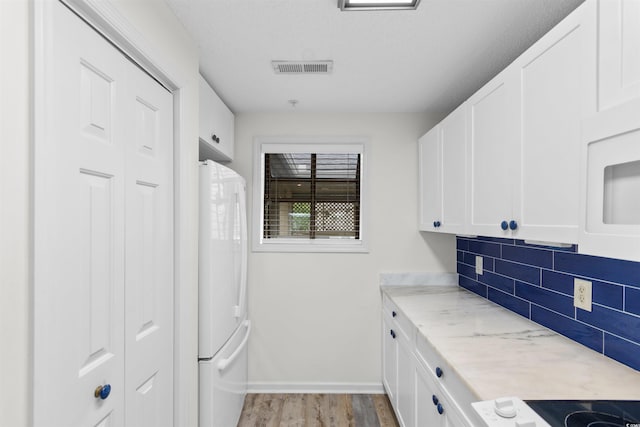 1551 Spinnaker Dr Unit 5935, North Myrtle Beach, SC 29582 - laundry area featuring light wood-type flooring and cabinet space