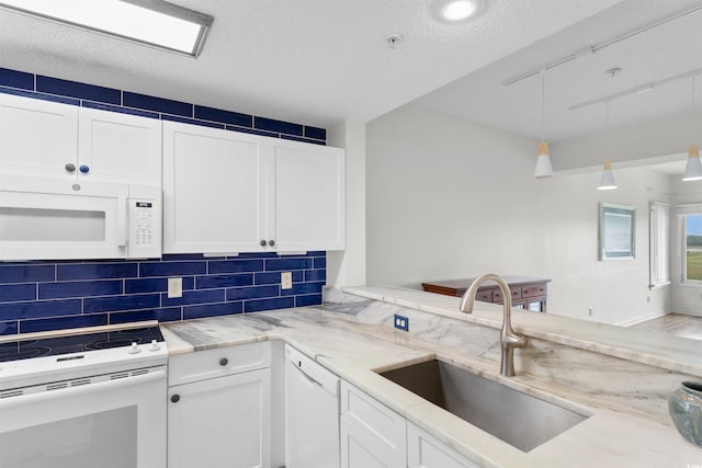 1551 Spinnaker Dr Unit 5935, North Myrtle Beach, SC 29582 - kitchen with white appliances, white cabinetry, tasteful backsplash, light stone counters, and a textured ceiling