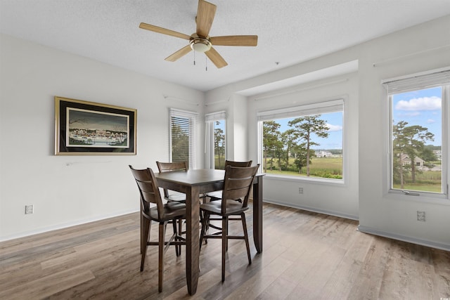 1551 Spinnaker Dr Unit 5935, North Myrtle Beach, SC 29582 - dining room featuring light wood-style flooring, ceiling fan, and a textured ceiling